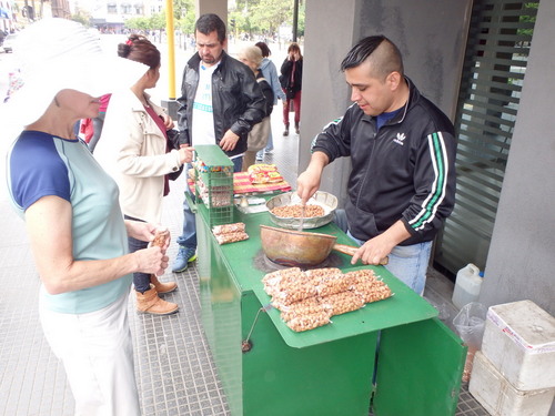 Teresa is buying some roasted nuts from a street vendor.